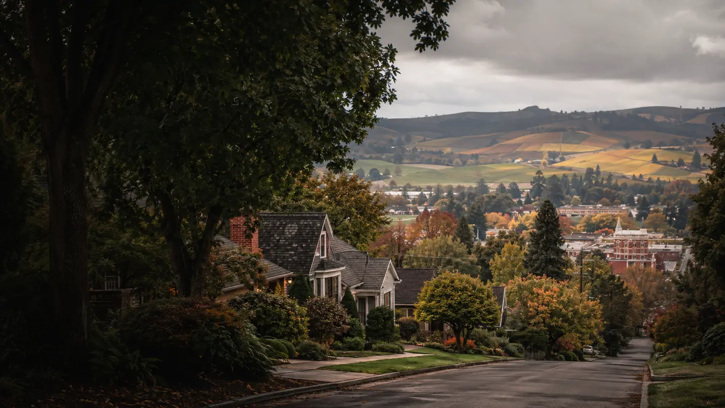 Newberg neighborhood homes near a walkable downtown with vineyard-covered hills beyond